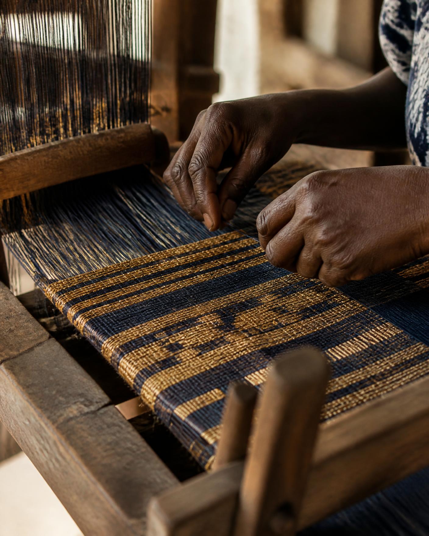 Reference image of narrow-strip Kente being woven by hand
